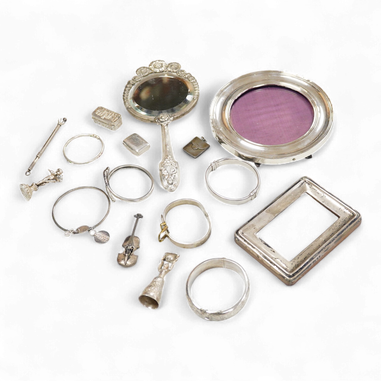 A small group of silver items including a William IV vinaigrette, William Simpson, Birmingham, 1835, 30mm, a later stamp case, two mounted photograph frames, two hinged bangles, together with a group of sterling or white